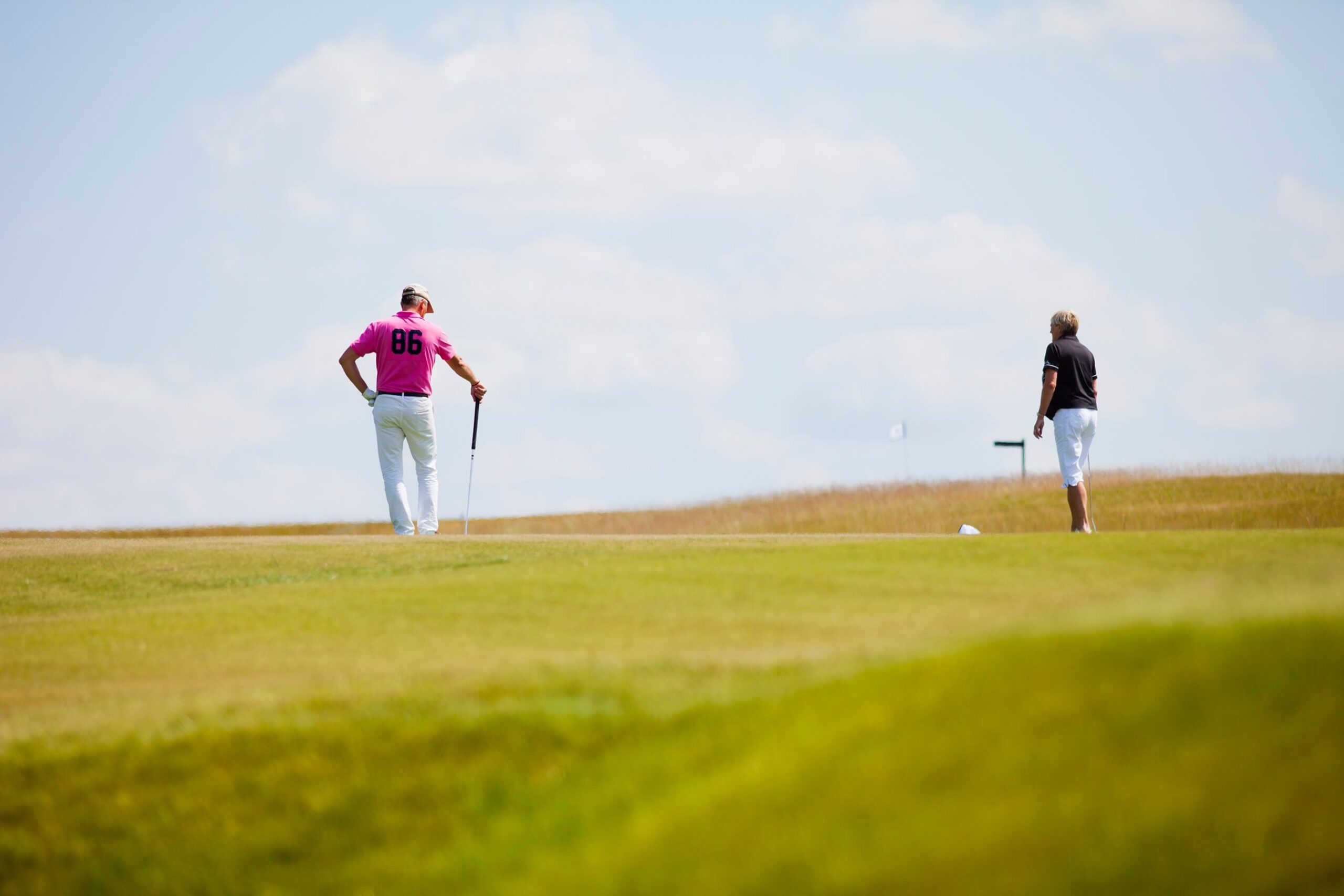 men-playing-golf-on-field-against-sky-2024-10-11-10-45-42-utc.jpg